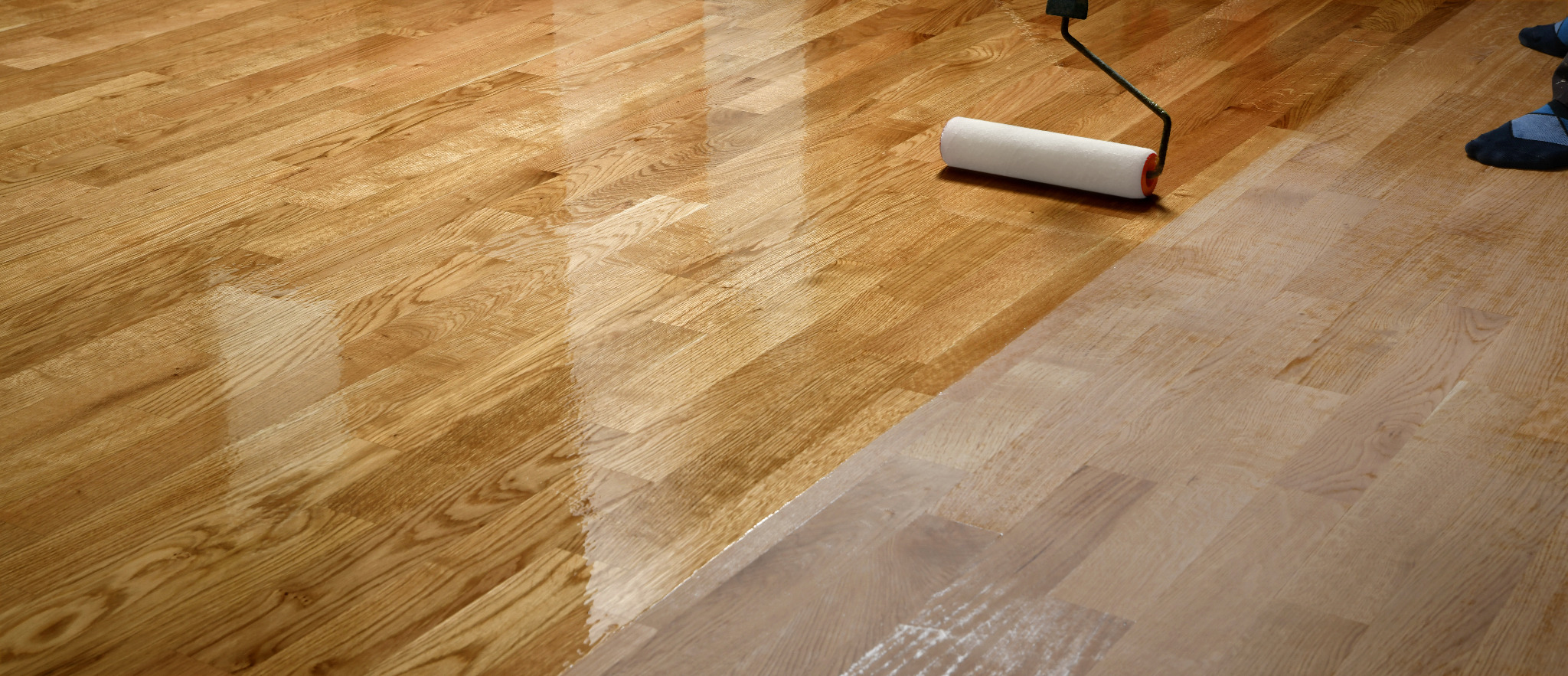 Wood Floor Waxing in Chelsea on European oak strip floor (solid hardwood) — roller applying hardwax, showing the contrast between raw sanded oak and the newly waxed sheen.