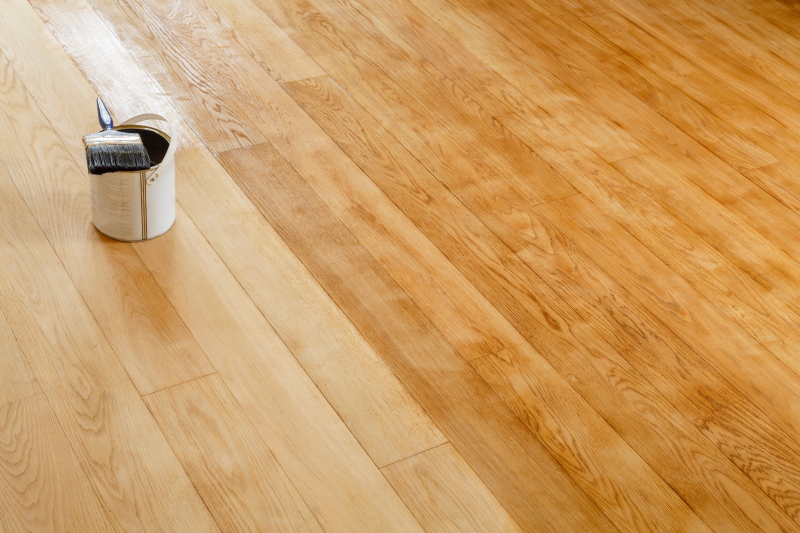 Wood Floor Waxing in Chelsea – Oak Hardwood Floorboards (Solid Oak) Before & After Wood Floor Waxing in Chelsea on oak hardwood floorboards (solid oak) showing a before-and-after finish with wax tin and brush.