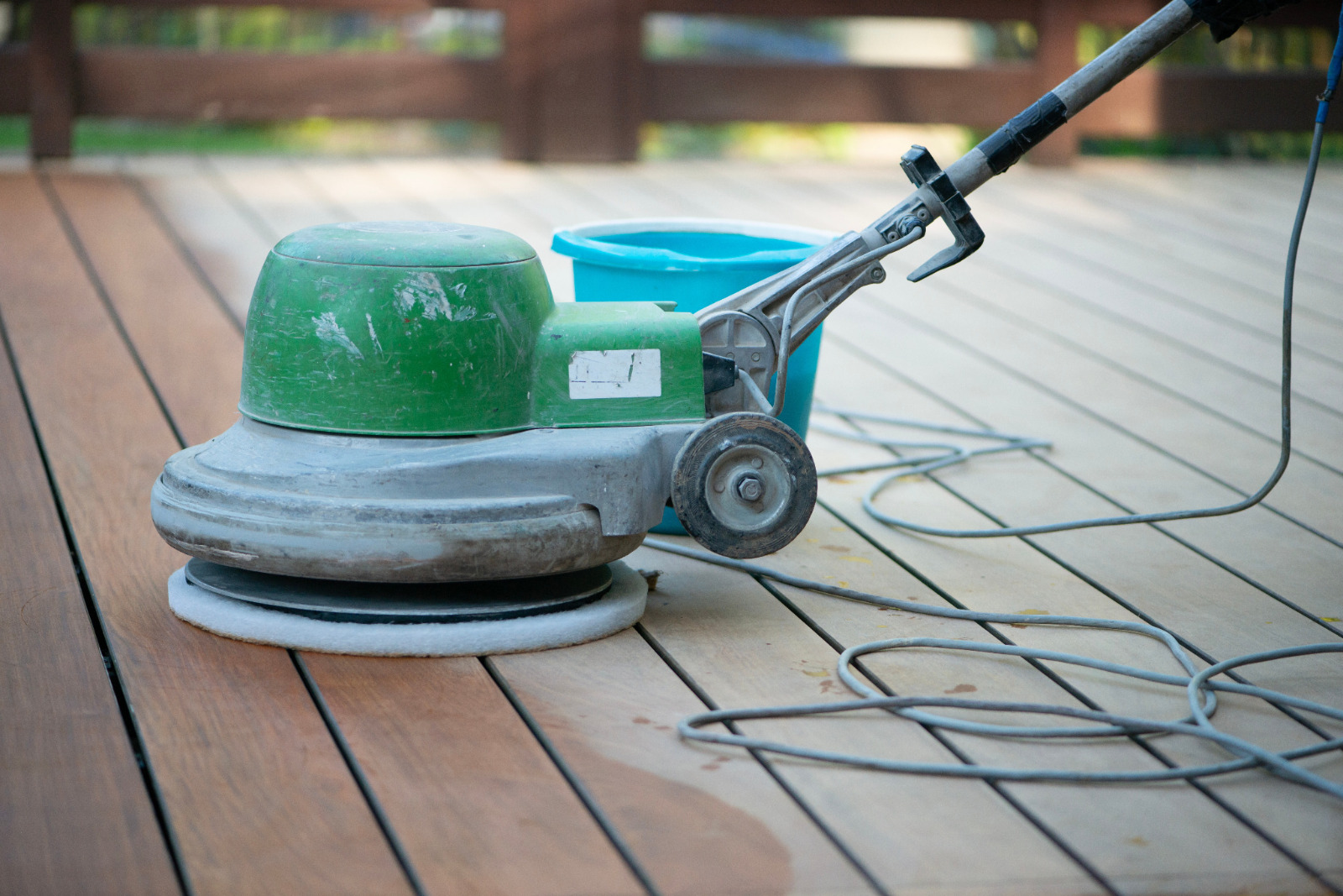 Professional deck sanding in Chelsea on a timber garden decking floor, using a sanding machine to restore smooth, clean wooden boards.