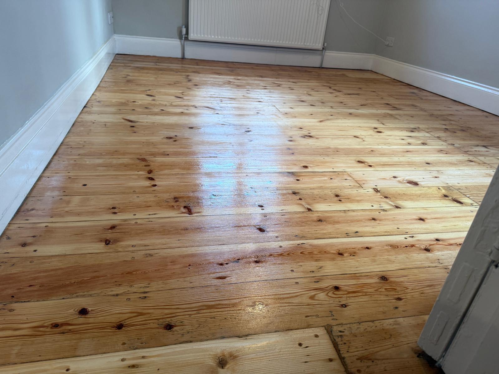 Wood Floor Sanding in Chelsea on freshly restored pine softwood bedroom floorboards with a clear, even finish.