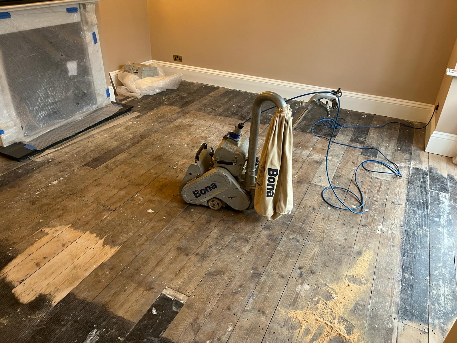 Wood Floor Sanding Chelsea – Bona sanding solid timber floorboards Wood Floor Sanding in Chelsea on original solid timber floorboards, with a Bona sanding machine removing the old finish for a smooth restoration.